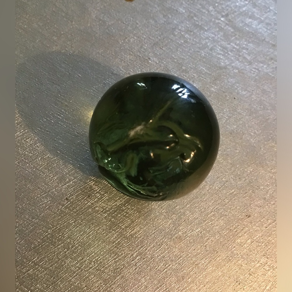 Vintage olive green shooter marble with swirled grooves.